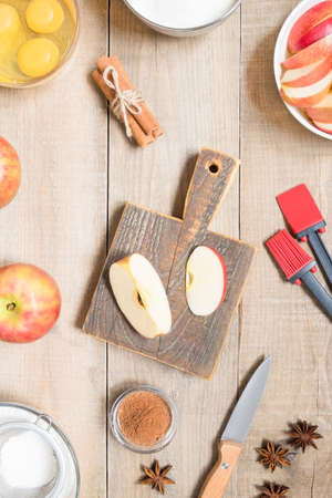 Top view raw ingredients for cooking apple pie on wooden background. Bakery backgroundの写真素材