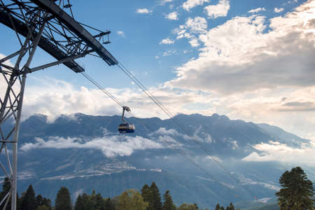 Gazprom, Krasnaya Polyana, Sochi, Russia - September 09, 2020: cable car against the background of a mountain landscape at sunset.のeditorial素材