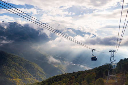 Gazprom, Krasnaya Polyana, Sochi, Russia - September 09, 2020: cable car against the background of a mountain landscape at sunset.のeditorial素材