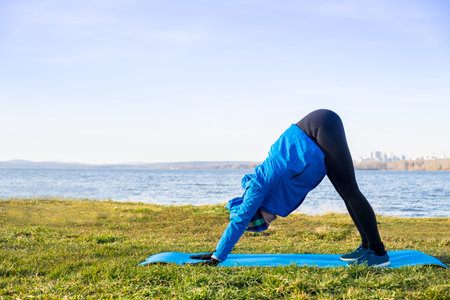 Woman doing exercise in outdoor workout in warm clothes.