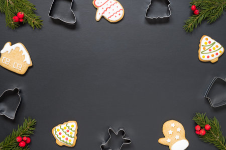 Forms for cooking and christmas cookies on black background with copy space.