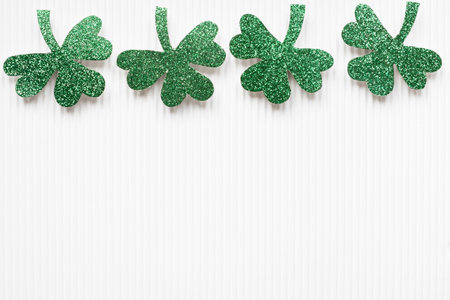 St Patrick's Day shamrocks on white background with copy space.