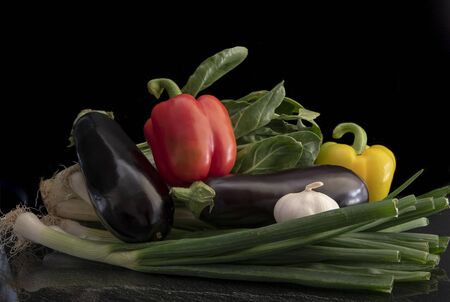 Still life with fresh garden vegetables isolated on black backgroundの写真素材