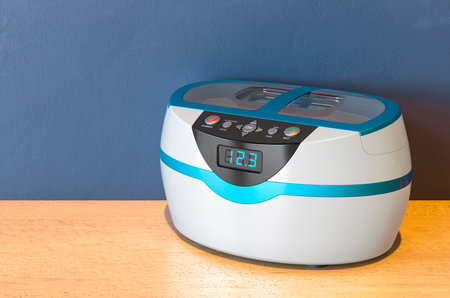 Nail Sterilizer, Ultrasonic Cleaner Disinfection on the wooden table. 3D rendering