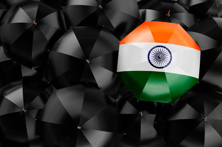 Umbrella with Indian flag among black umbrellas, top view. 3D rendering