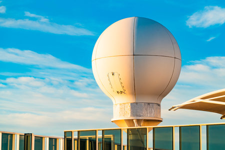 Spherical Radar Dome on Rooftop Against Blue Sky. Modern Technology Structureの写真素材