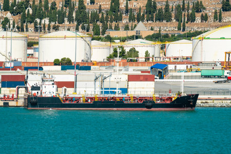 Oil tanker at Port of Barcelona with Montjuic cemetery backdropの写真素材
