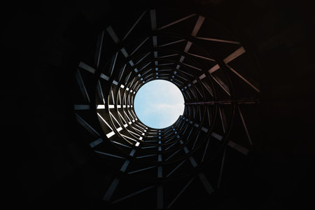 View from the bottom of a deep well on the blue sky above.の写真素材