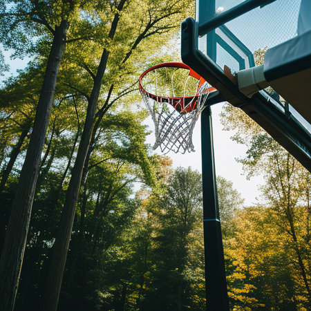 Action shot of basketball falls through basketball hoop and net on nature backgroundの素材