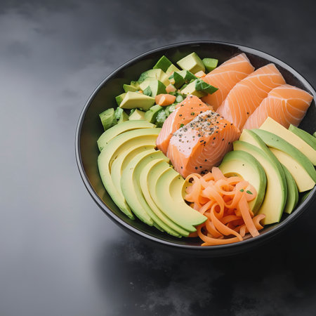 Organic poke bowl with salmon, avocado and vegetables on dark backgroundの素材