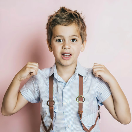 Smiling kids cute adorable sweet child boys on pink backgroundの素材