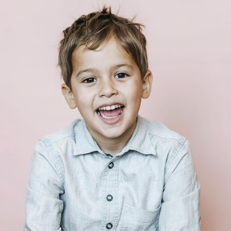 Smiling kids cute adorable sweet child boys on pink backgroundの素材