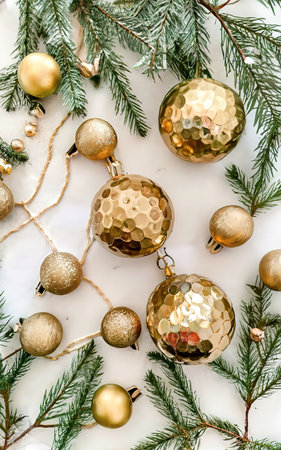 Decorative gold balls and sprigs of spruce on a white backgroundの素材