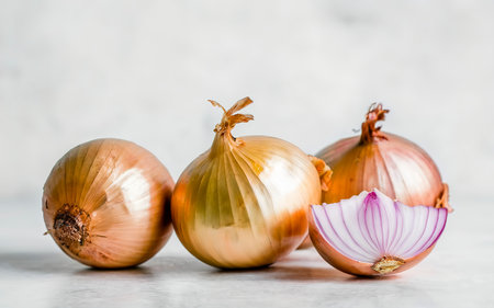 Ripe fresh golden onions on a white backgroundの素材
