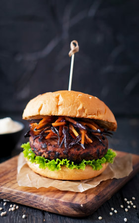 vegan burger with black rice cutlet and fried leeks. Healthy cuisine, fast foodの素材