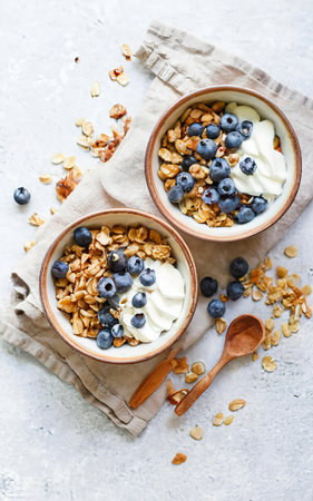 Homemade granola with ripe blueberries, top down viewの素材