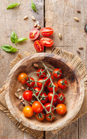 Cherry tomatoes in rustic bowl. top viewの素材