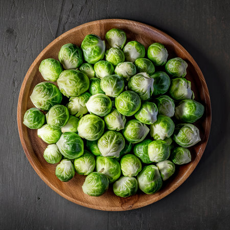 Fresh Brussel cabbage on a wooden plate. On a rustic dark backgroundの素材