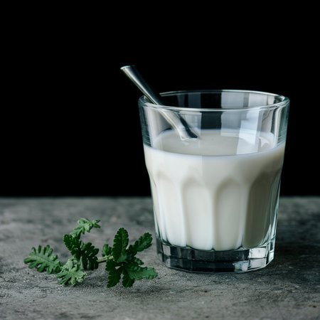 Fresh homemade milk on the table in a glass. On a black backgroundの素材