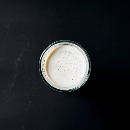 Fresh homemade milk on the table in a glass. On a black backgroundの素材
