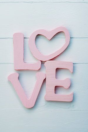 Message of love with wood pink letters.の素材