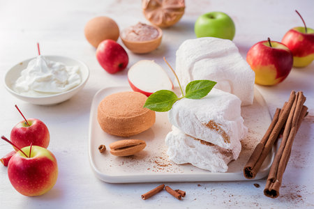 Apple paste, pastille, zephyr, marshmallow with cinnamon on a white backgroundの素材
