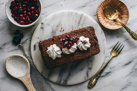 Chocolate loaf cake slice decorated on a marble boardの素材