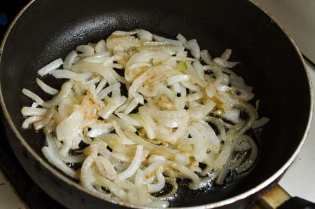 Onion is fried in a panの写真素材