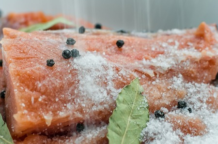 Fresh salmon with spices on wooden tableの写真素材