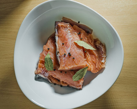 red fish with spices on the white plateの写真素材