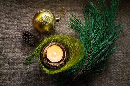 Christmas composition with burning candle and decorationsの写真素材