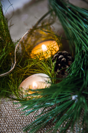 Christmas composition with burning candle and decorationsの写真素材