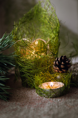 Christmas composition with burning candle and decorationsの写真素材