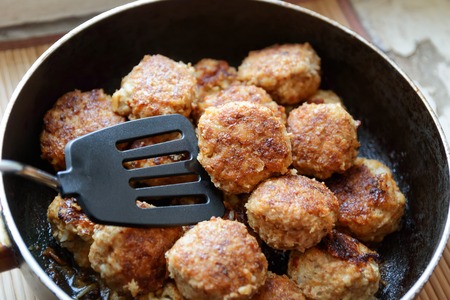 meatball in a pan while fryingの写真素材