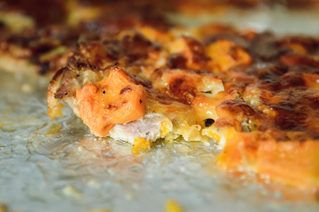 meat baked with cheese in the oven on a baking sheet covered with foilの写真素材
