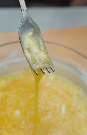 pour the flour into a glass bowl with broken egg, cookingの写真素材