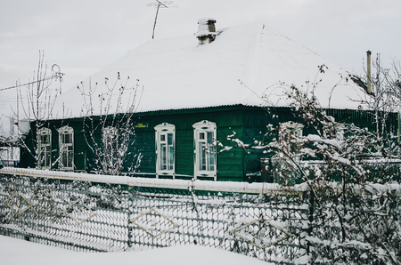 Winter landscape. wood small house in snowの写真素材