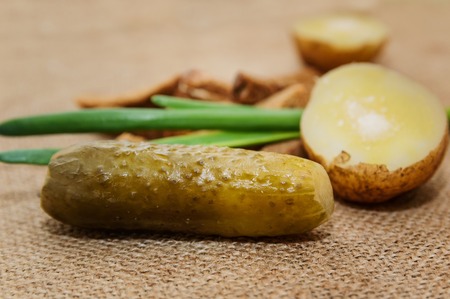 Boiled potatoes in a peel with salt and a green onion on a close-up table. Healthy food.の写真素材