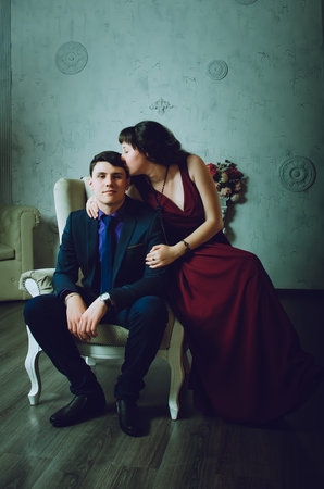 Attractive guy with a girl kissing in the roomの写真素材