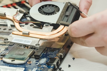 Repair laptops, close-up of hands and dismantled old computer.の写真素材