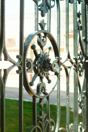 A beautiful fragment of a black metal fence close-up.の写真素材
