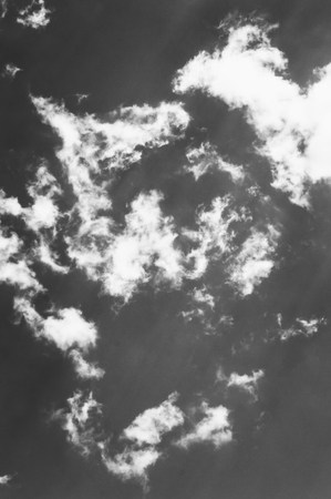 Clouds against the dark blue sky. Heavenly background. ?lack and white photography.の写真素材