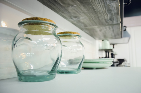 Empty glass containers on the kitchen shelf.の写真素材