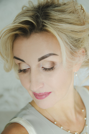 Portrait of a beautiful woman 40 years old with blond hair.の写真素材