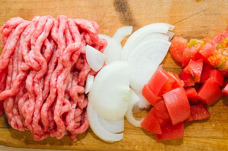 Raw minced meat and fresh vegetables. Ingredients for home cooking.の写真素材