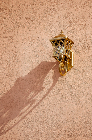 Beautiful openwork decorative lantern on the wall of the house.の写真素材
