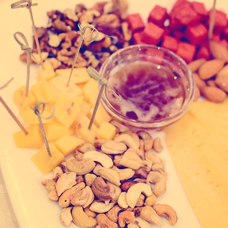 Honey, nuts and cheese. Festive table setting at the restaurant.の写真素材