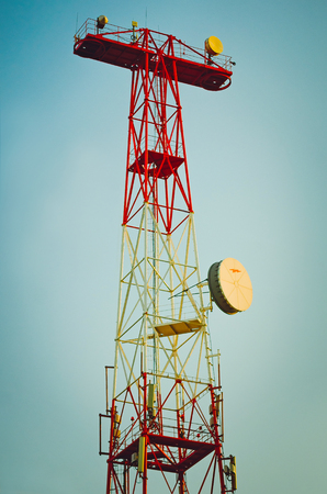 High observation tower of red color against the sky.の写真素材