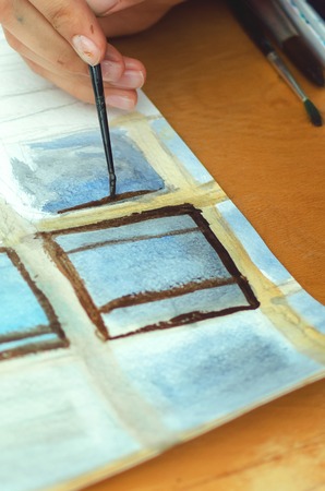 The girl draws paints. Close-up, vertical photograph.の写真素材