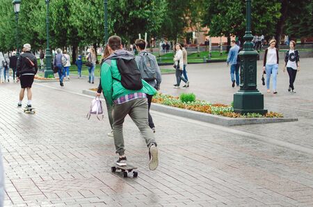 MOSCOW, RUSSIA - July 05, 2018: Men ride a skateboard in the Alexander Garden in the city of Moscow.のeditorial素材